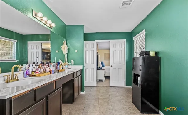 a bathroom with a double vanity sink and mirror