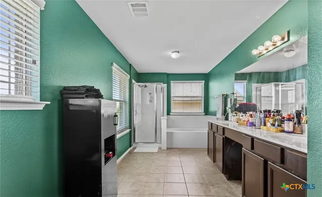 a kitchen with stainless steel appliances granite countertop a refrigerator and a stove