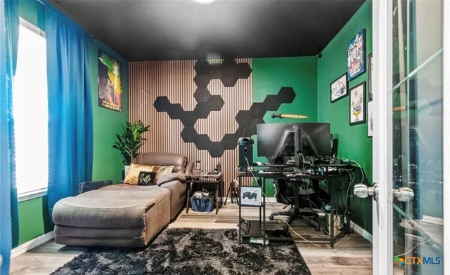 a living room with furniture and a painting