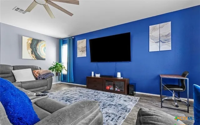 a living room with furniture and a flat screen tv