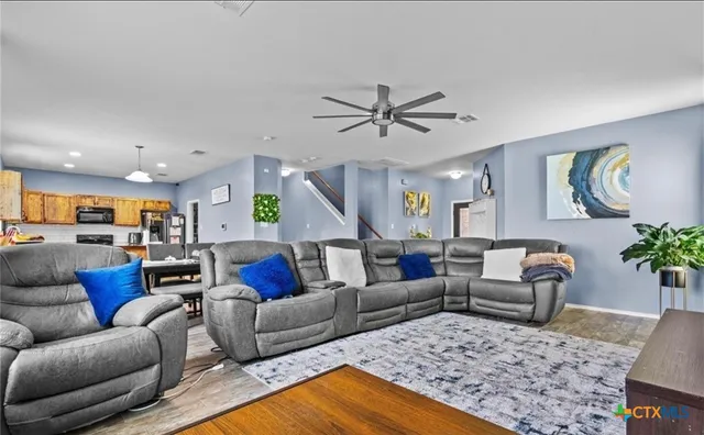 a living room with furniture and wooden floor