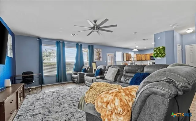 a living room with furniture and a large window