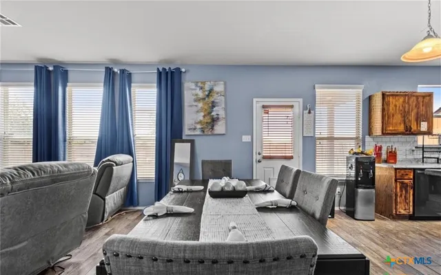 a living room with furniture and large windows