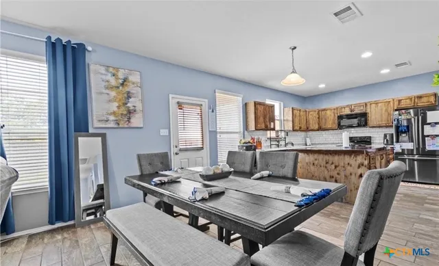 a view of a dining room with furniture window and wooden floor
