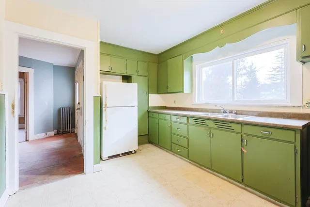 a kitchen with a refrigerator and a sink