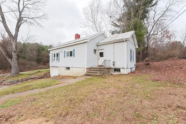 a view of a house with a yard covered in snow