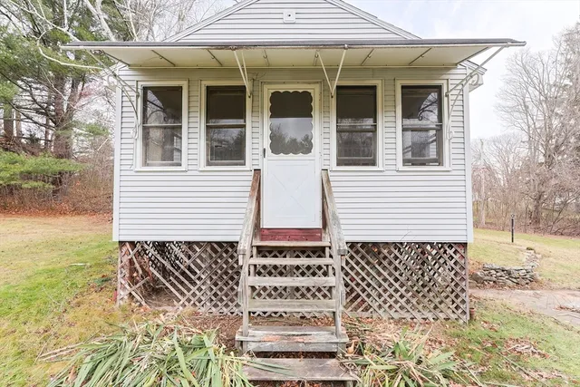 a view of a house with a door and wooden floor