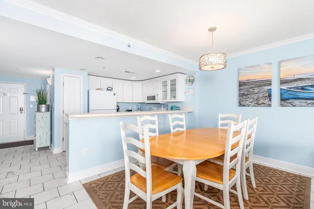 a view of a dining room and kitchen with a table chairs and chandelier
