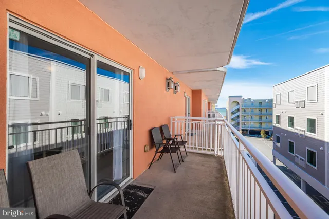 a view of a chairs and table in the balcony