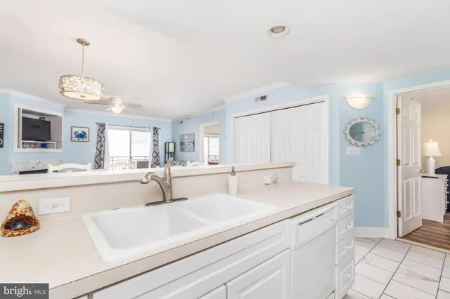 a view with kitchen island sink and refrigerator