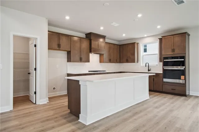 a kitchen with stainless steel appliances granite countertop a refrigerator sink and cabinets