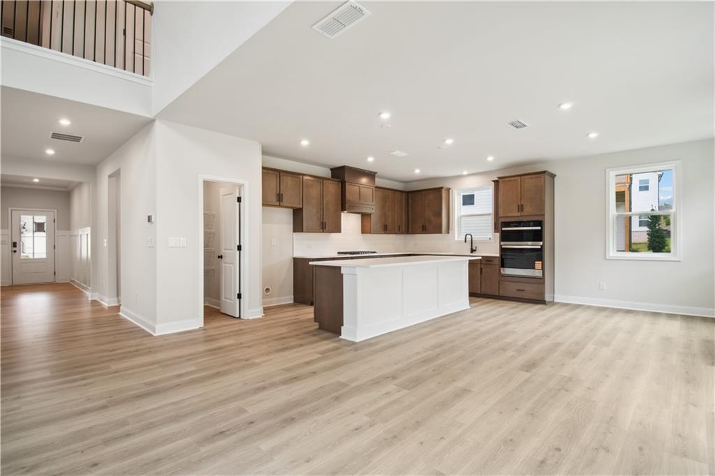 719 Crossroad Court Southwest Powder Springs, GA 30127 - Photo 12 of 27 a view of a kitchen with stainless steel appliances kitchen island a large counter top and floors