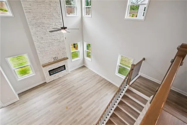 a view of an empty room with window and wooden floor