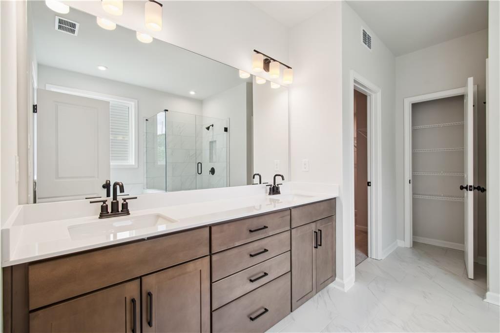 719 Crossroad Court Southwest Powder Springs, GA 30127 - Photo 18 of 27 a bathroom with a double vanity sink mirror and double