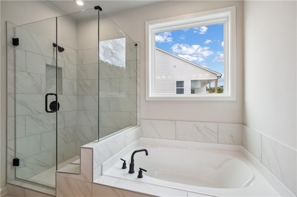 719 Crossroad Court Southwest Powder Springs, GA 30127 - Photo 20 of 27 a white bath tub sitting next to a shower