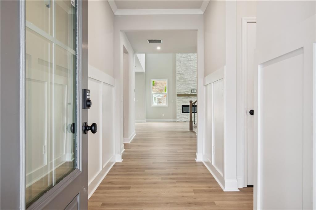 719 Crossroad Court Southwest Powder Springs, GA 30127 - Photo 2 of 27 a view of a hallway with wooden floor and a bathroom
