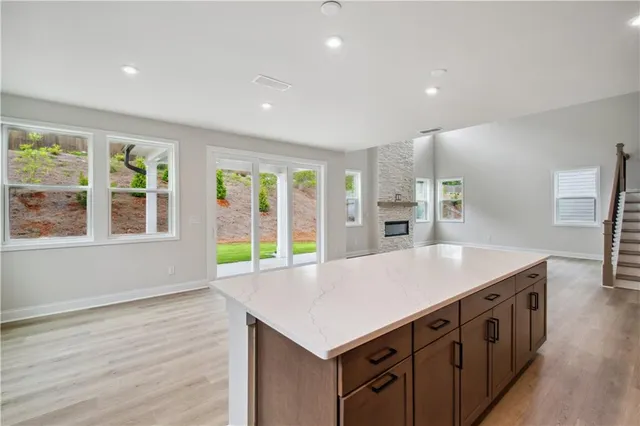 a kitchen that has a lot of counter space and wooden floor