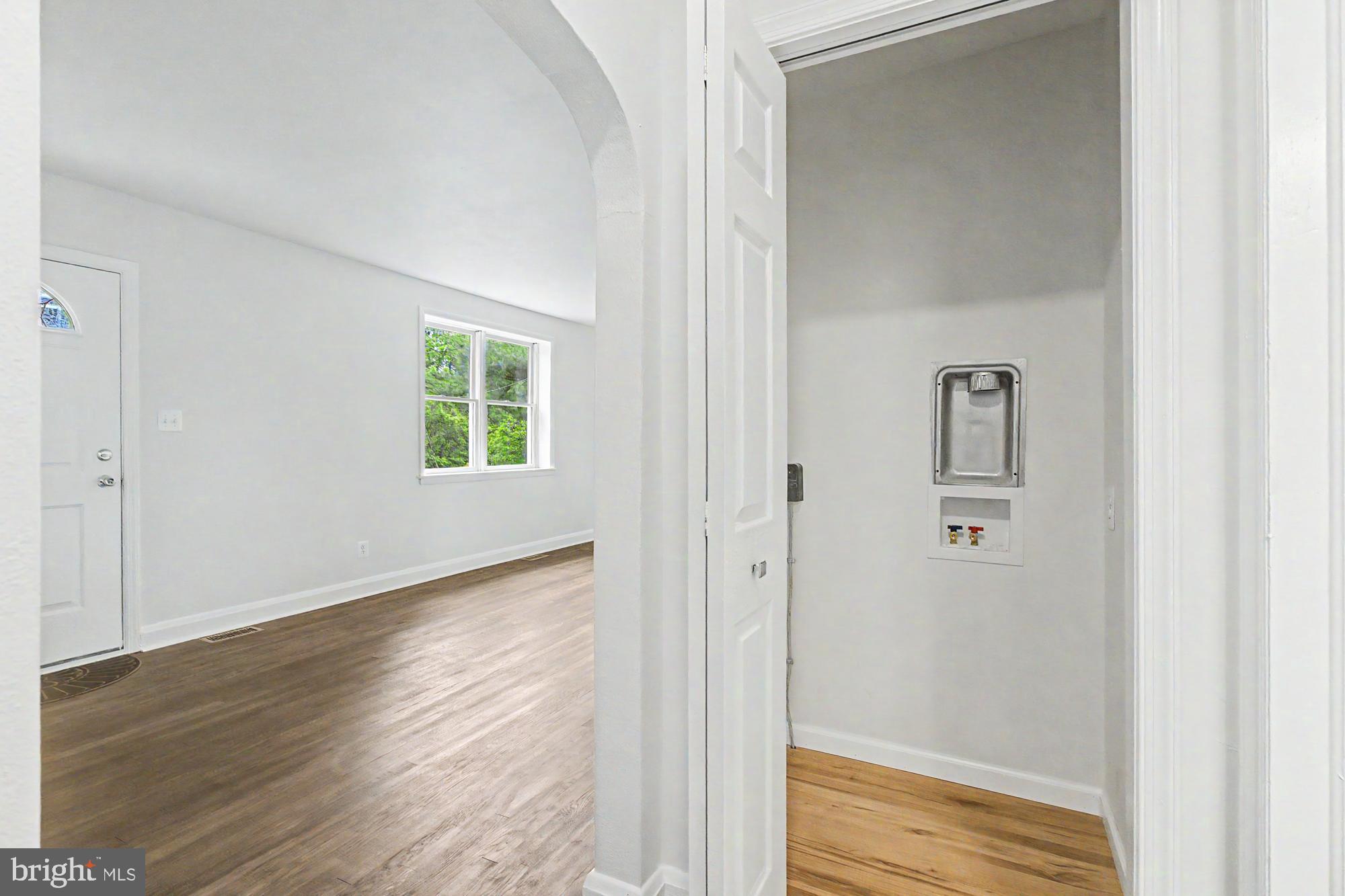 604 Prospect Mill Road Bel Air, MD 21015 - Photo 17 of 36 a view of a hallway with wooden floor and a bathroom