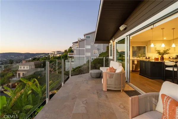 a living room with lots of furniture and kitchen view