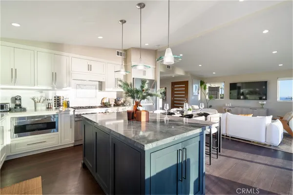 a kitchen with stainless steel appliances granite countertop sink stove top oven and cabinets