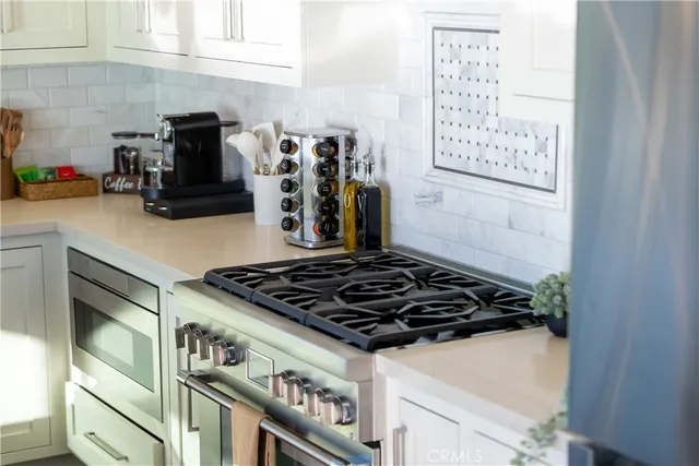 a kitchen with a sink and white appliances