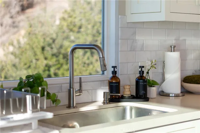 a dining hall with stainless steel appliances kitchen island granite countertop a dining table and chairs