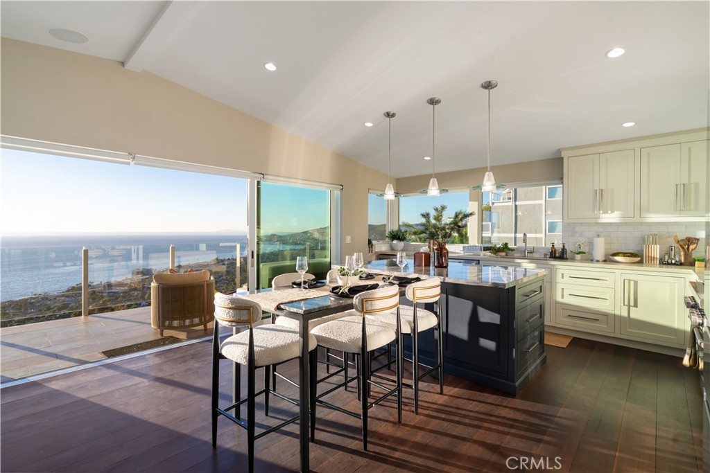 2192 Crestview Drive Laguna Beach, CA 92651 - Photo 20 of 54 a dining hall with stainless steel appliances kitchen island granite countertop a dining table and chairs