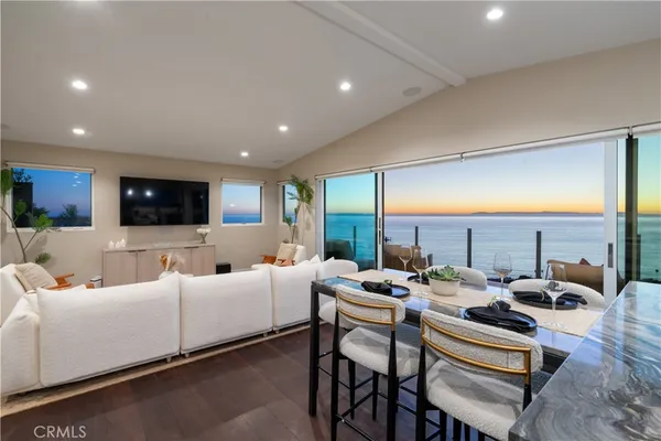 a living room with fireplace furniture and a chandelier