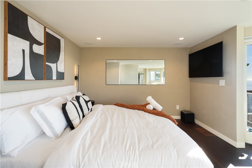 2192 Crestview Drive Laguna Beach, CA 92651 - Photo 32 of 54 a bedroom with a bed and a flat screen tv