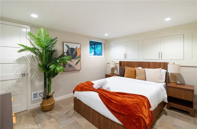 a bathroom with a granite countertop sink mirror vanity and toilet