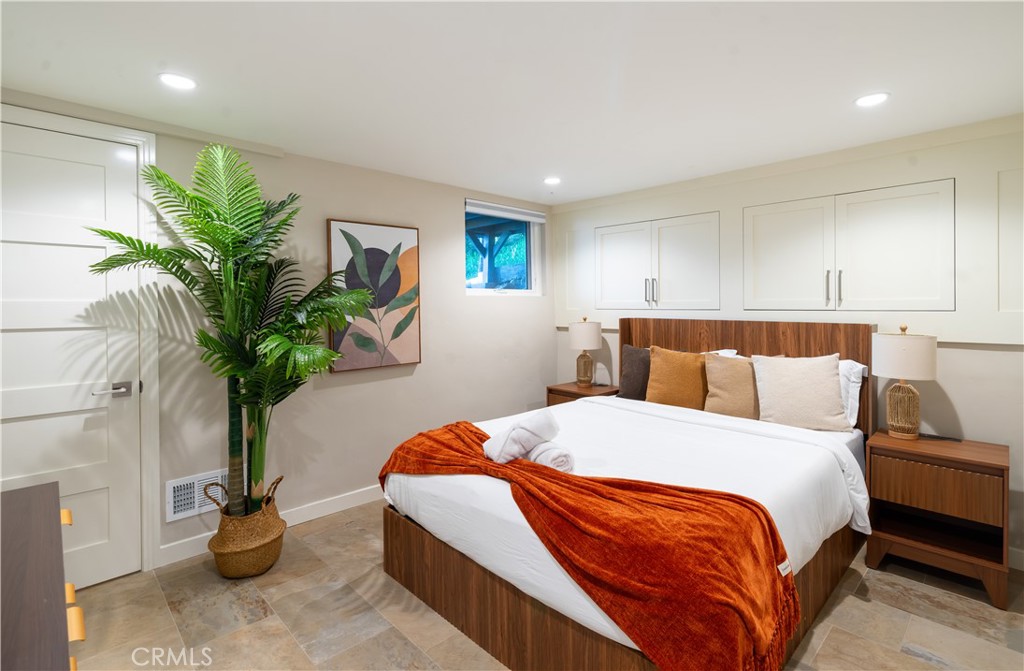 2192 Crestview Drive Laguna Beach, CA 92651 - Photo 36 of 54 a bedroom with bed and a potted plant