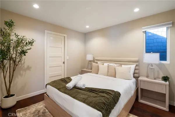 a bedroom with a bed and a painting on the wall