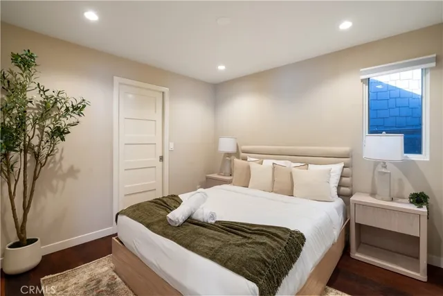 a bedroom with a bed and a painting on the wall