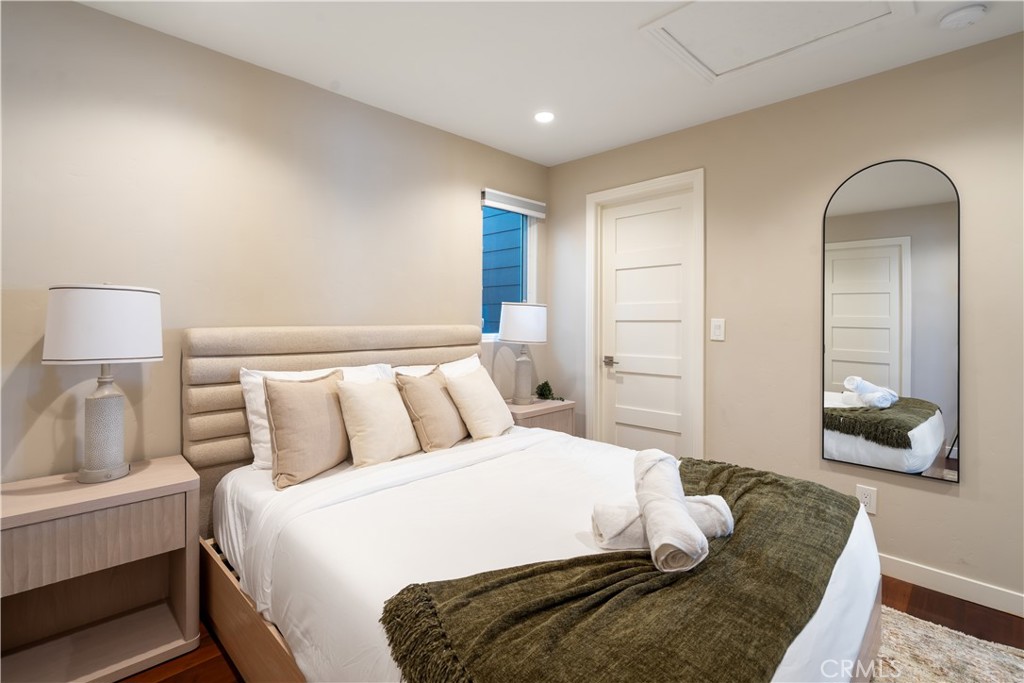 2192 Crestview Drive Laguna Beach, CA 92651 - Photo 40 of 54 a bedroom with a bed and a lamp