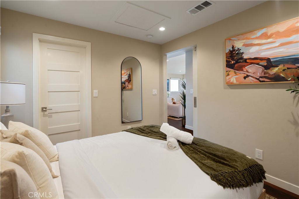 2192 Crestview Drive Laguna Beach, CA 92651 - Photo 41 of 54 a bedroom with a bed and a painting on the wall