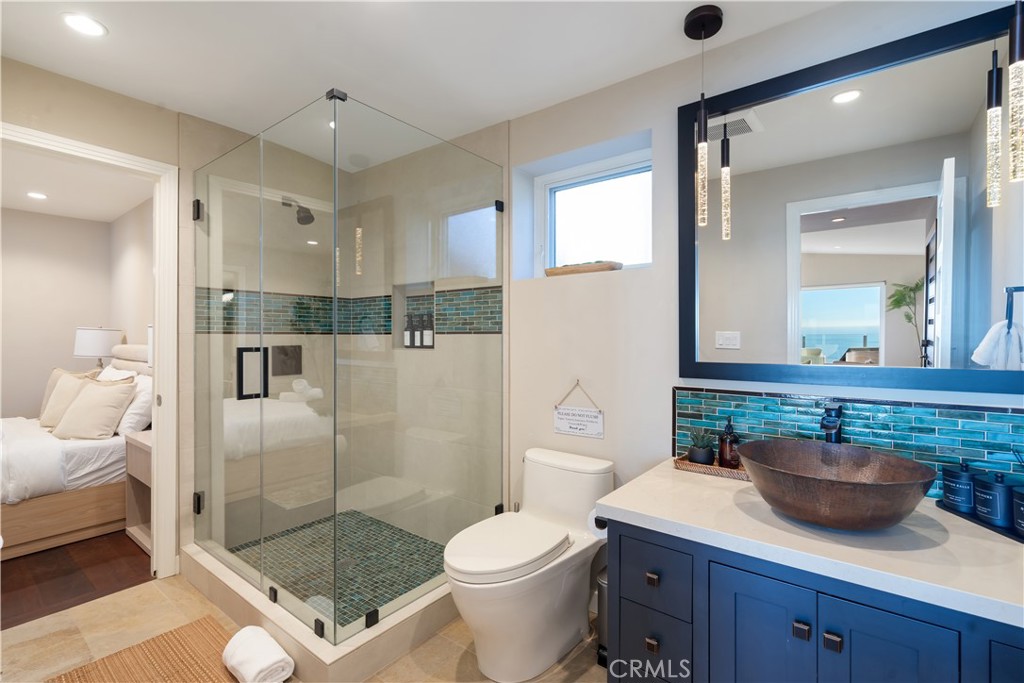 2192 Crestview Drive Laguna Beach, CA 92651 - Photo 42 of 54 a bathroom with a sink toilet a mirror and shower