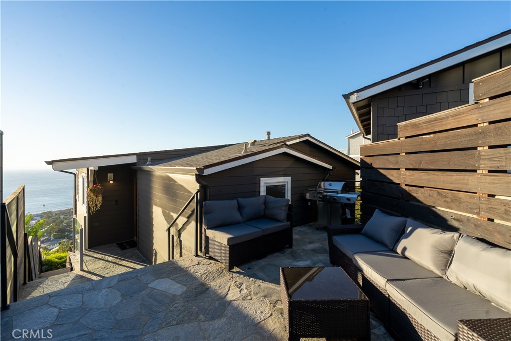 2192 Crestview Drive Laguna Beach, CA 92651 - Photo 48 of 54 a view of a patio with couches and a barbeque