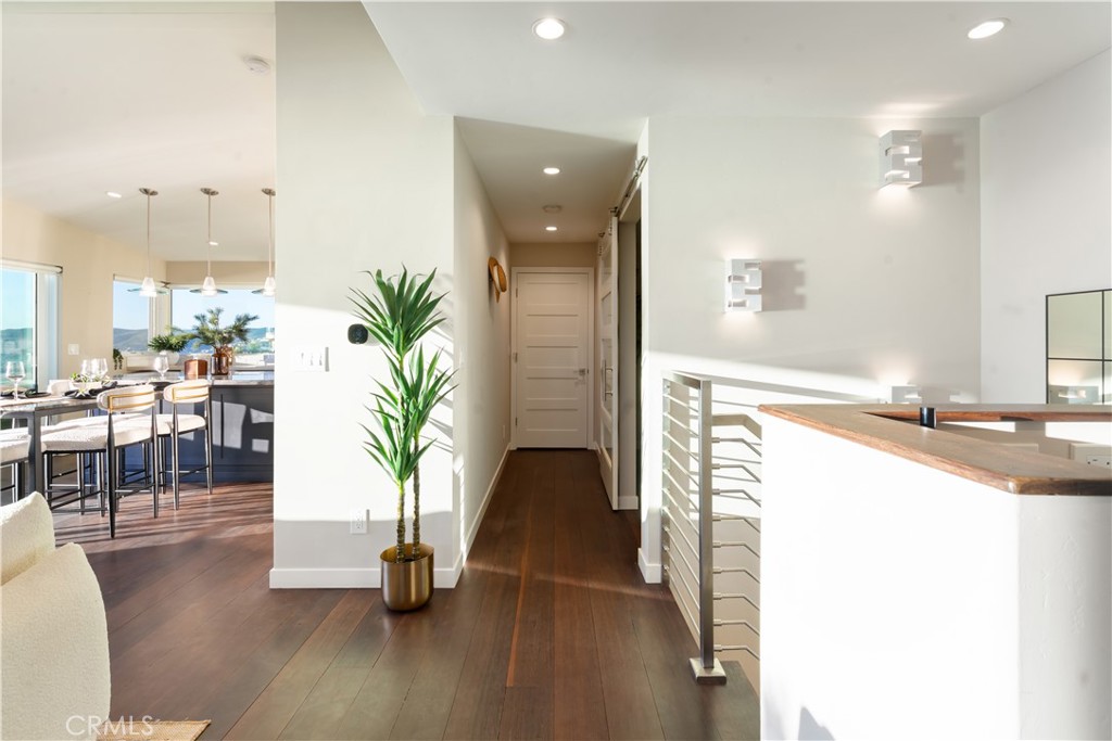 2192 Crestview Drive Laguna Beach, CA 92651 - Photo 5 of 54 a hallway with a potted plant on the kitchen counter top and sink