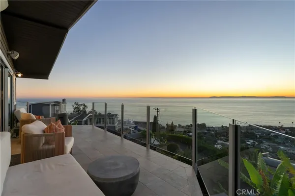 a balcony with furniture and a view of city