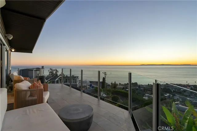 a balcony with furniture and a view of city