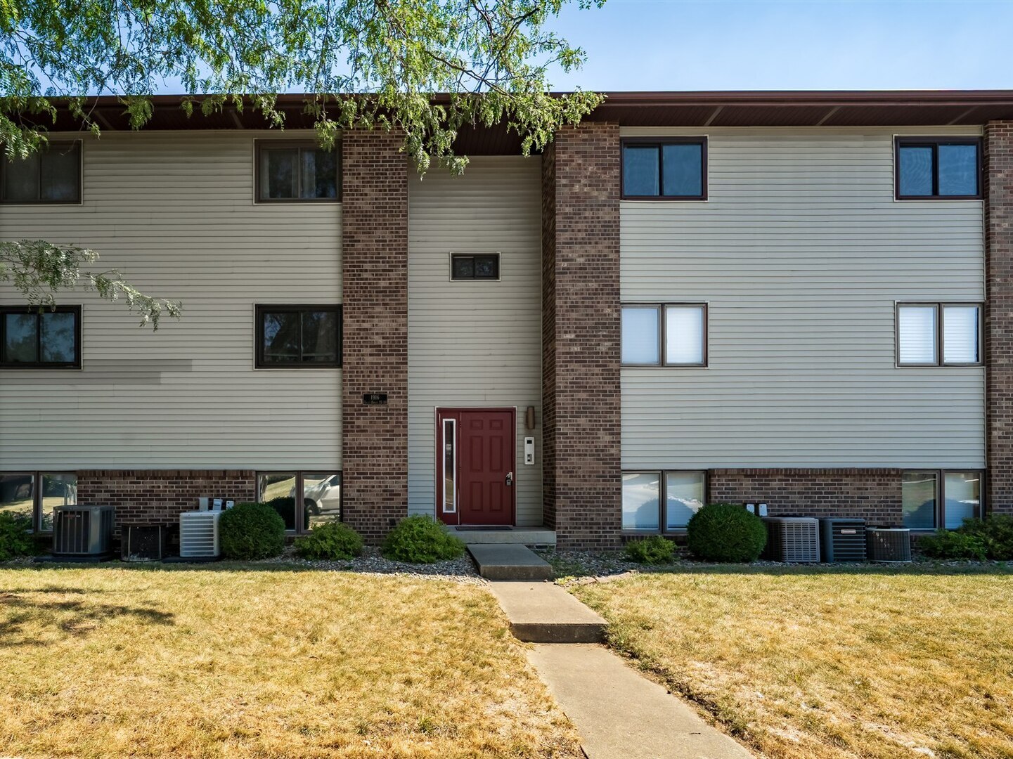 1916 Tracy Drive, Unit 26 Bloomington, IL 61704 - Photo 1 of 23 a view of a house with potted plants