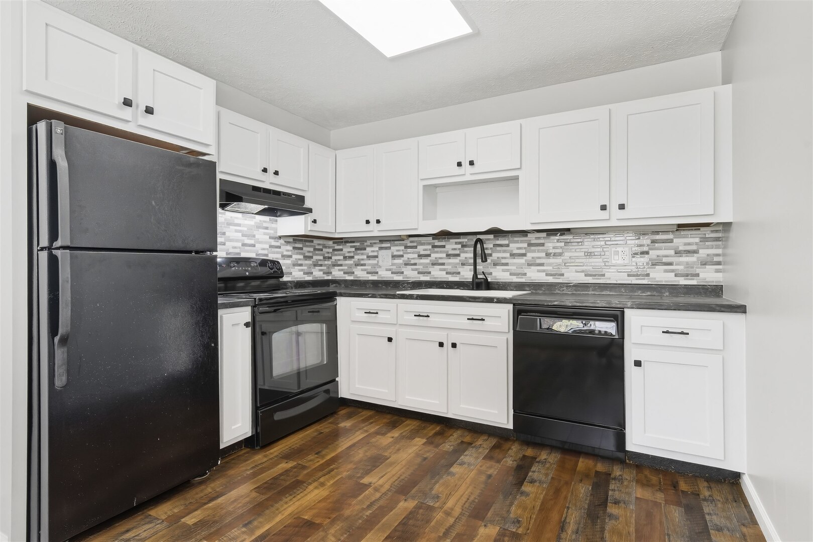 1916 Tracy Drive, Unit 26 Bloomington, IL 61704 - Photo 11 of 23 a kitchen with stainless steel appliances granite countertop a refrigerator sink and white cabinets