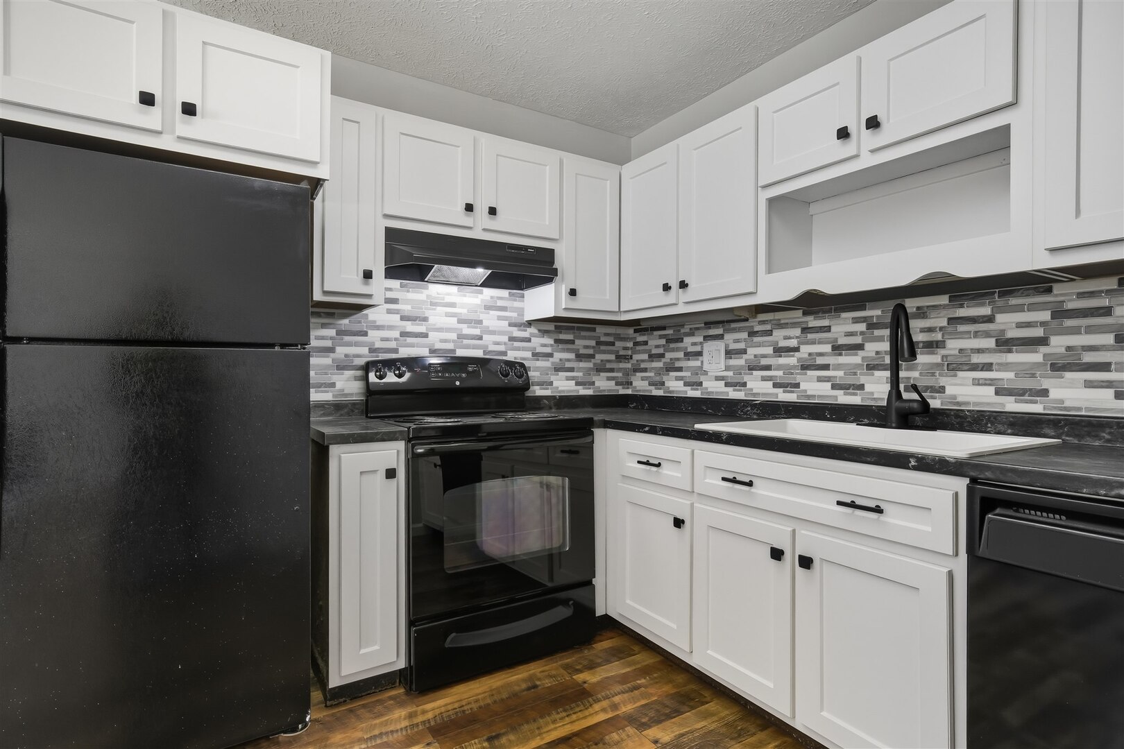 1916 Tracy Drive, Unit 26 Bloomington, IL 61704 - Photo 13 of 23 a kitchen with granite countertop white cabinets and stainless steel appliances