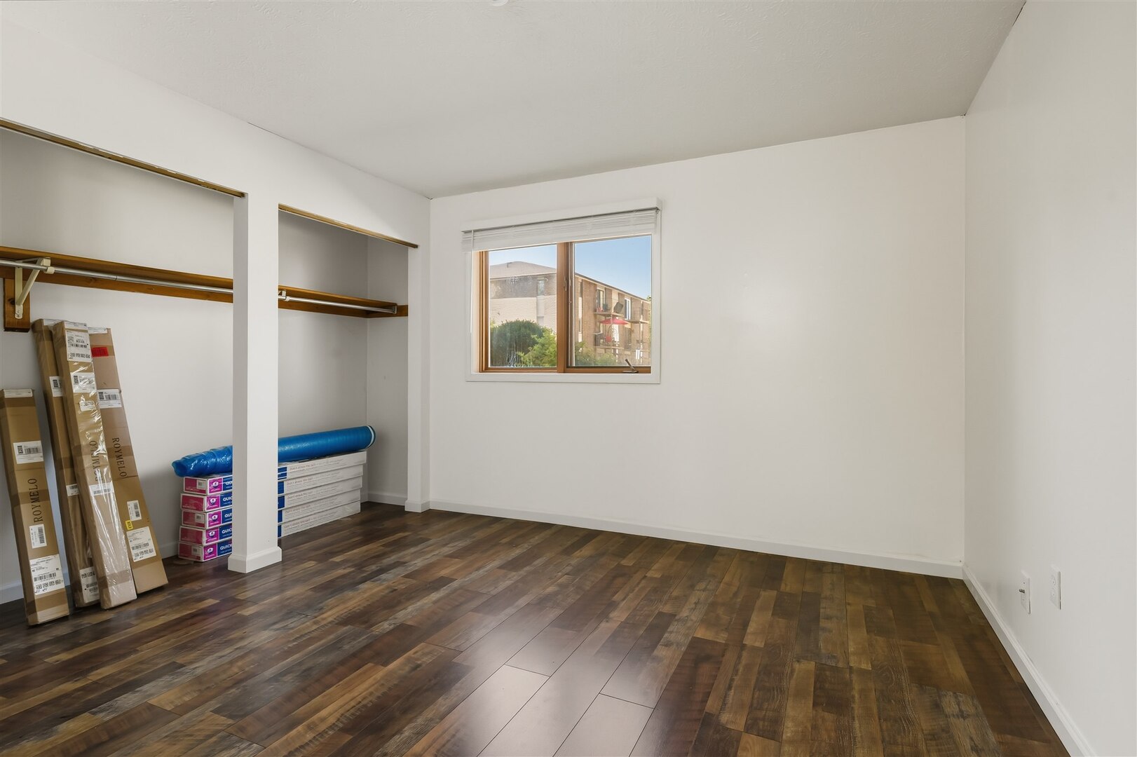 1916 Tracy Drive, Unit 26 Bloomington, IL 61704 - Photo 18 of 23 an empty room with wooden floor and closet