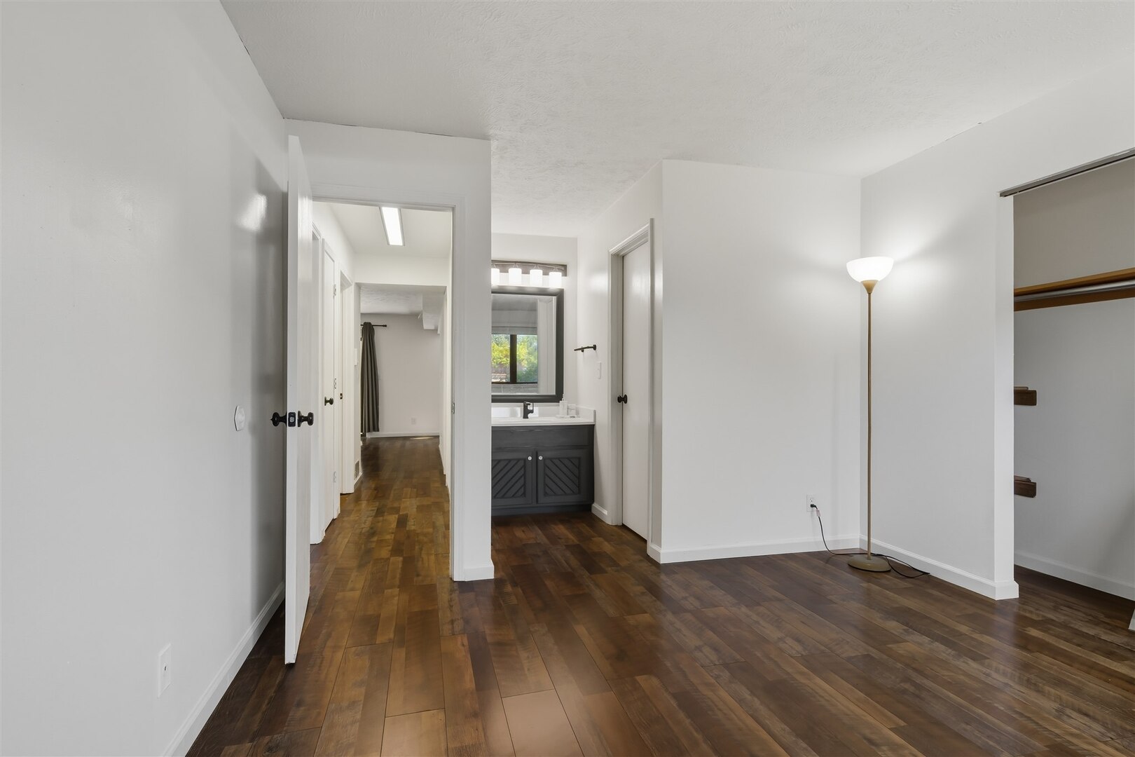 1916 Tracy Drive, Unit 26 Bloomington, IL 61704 - Photo 19 of 23 an empty room with wooden floor and a bathroom
