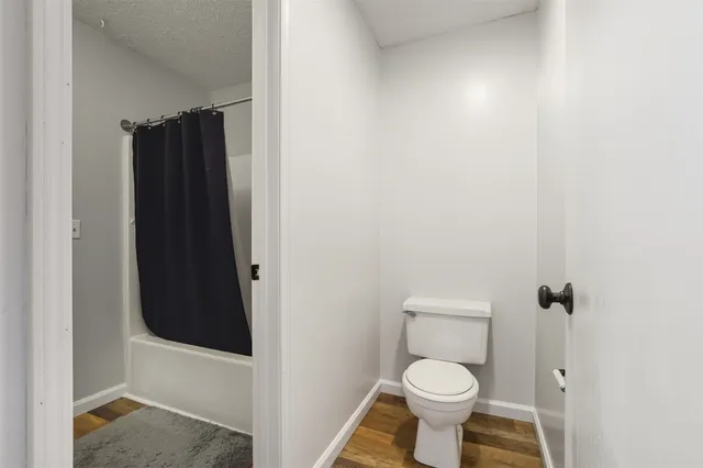 a view of a brick house with potted plants