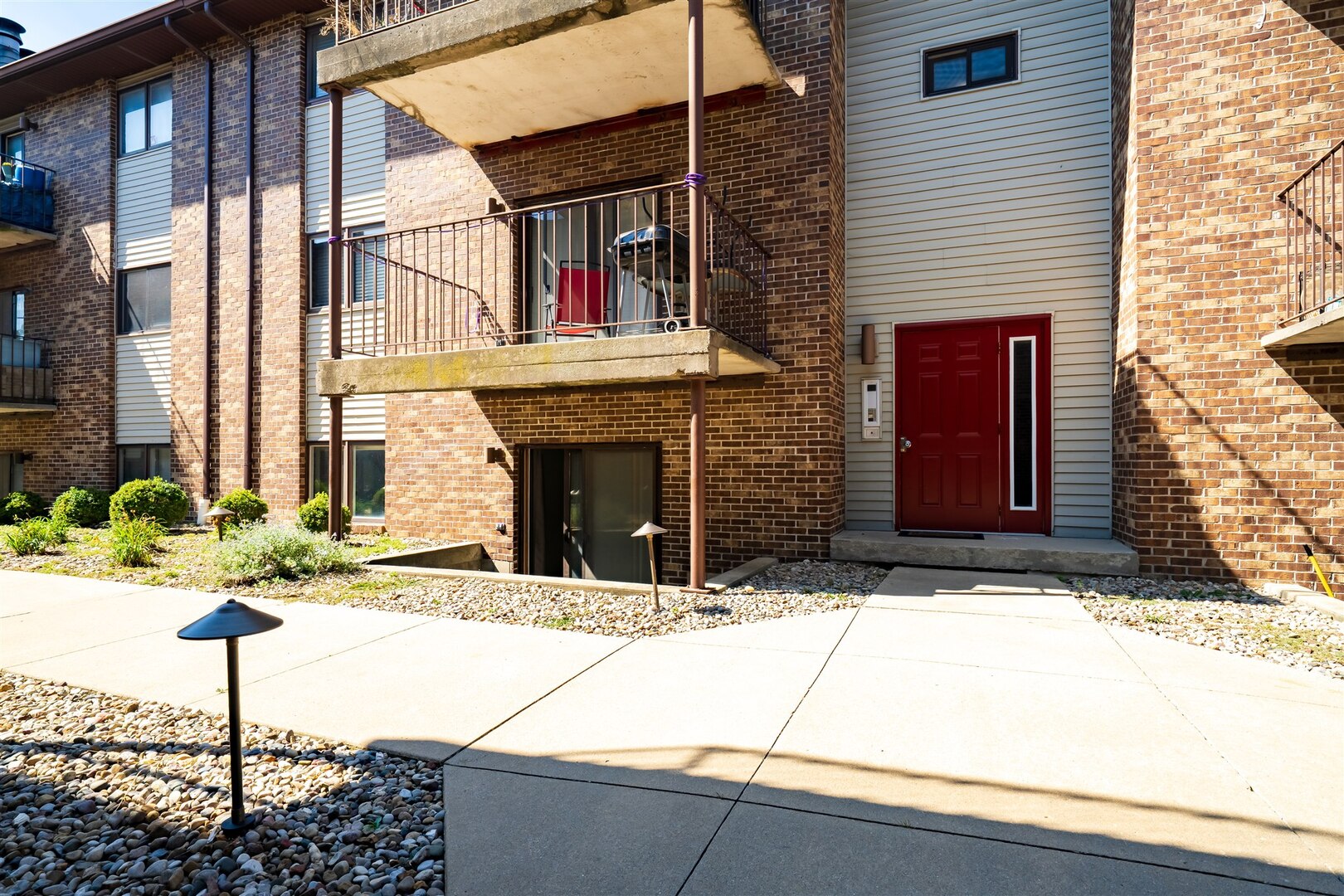 1916 Tracy Drive, Unit 26 Bloomington, IL 61704 - Photo 22 of 23 a view of a brick house with potted plants