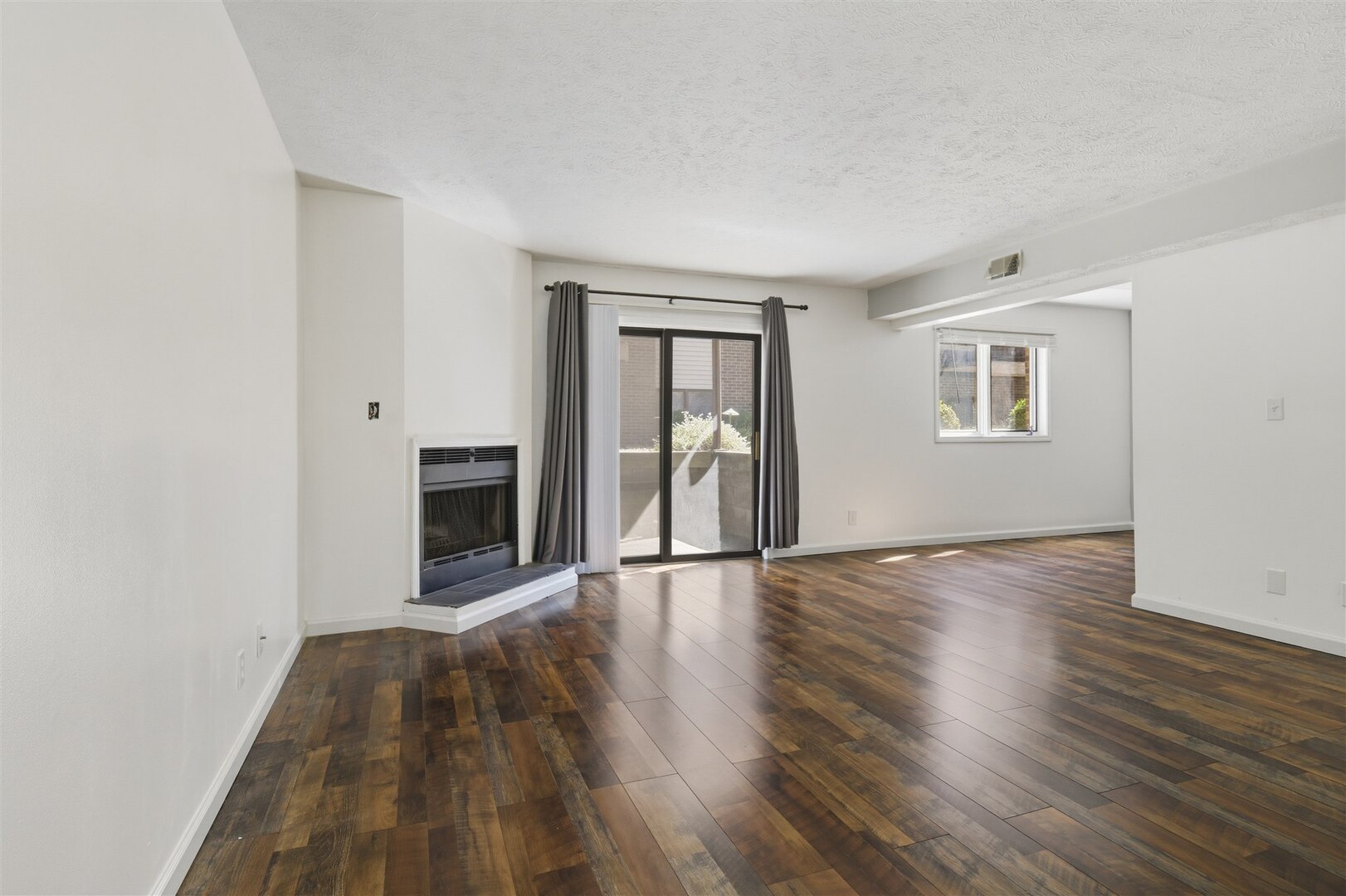 1916 Tracy Drive, Unit 26 Bloomington, IL 61704 - Photo 7 of 23 a view of an empty room with wooden floor and a window