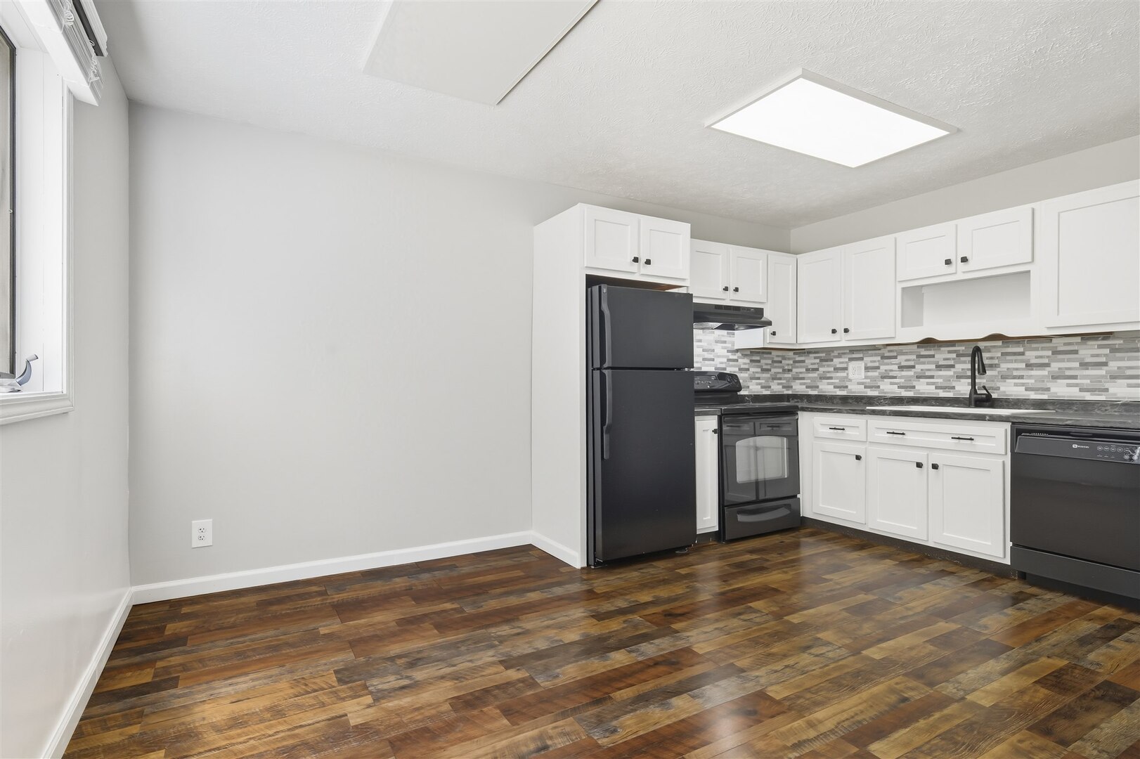 1916 Tracy Drive, Unit 26 Bloomington, IL 61704 - Photo 10 of 23 a kitchen with a refrigerator sink and cabinets