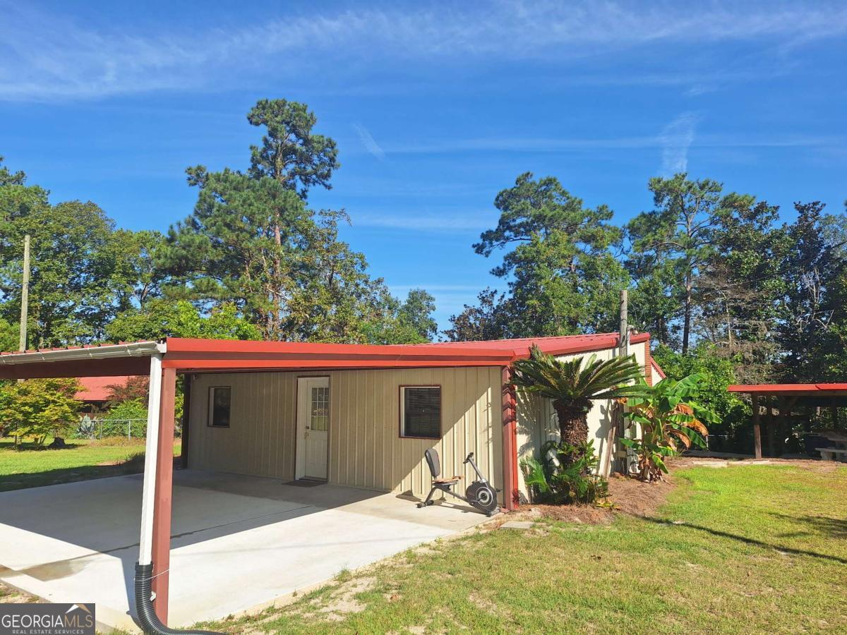 163 High Bluff Road Baxley, GA 31513 - Photo 2 of 52 a view of a porch with a tree
